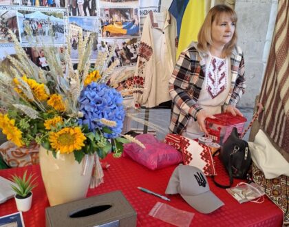 Stand d’Ukraine-Lorraine : bouquet de tournesols et d’hortensias, urne pour les dons et photos des activités